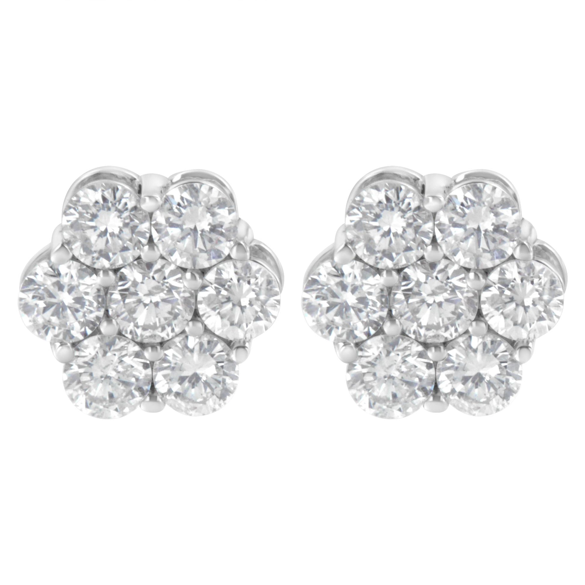 Pair of white metal cluster earrings with multiple round white gemstones in prong settings, front view.