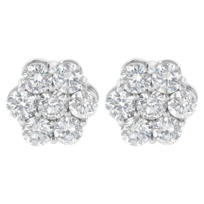 Pair of white metal cluster earrings with multiple round white gemstones in prong settings, front view.