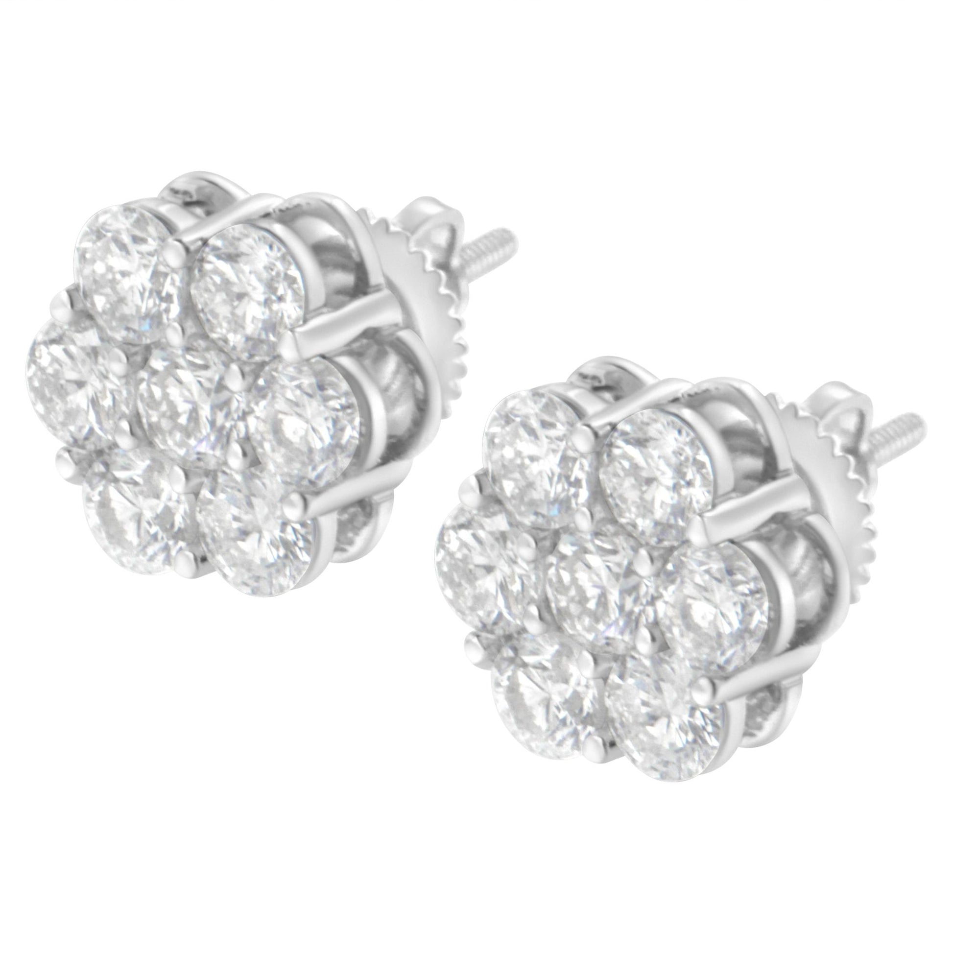 Pair of white metal stud earrings with multiple round white gemstones in prong settings, shown from a front angle.