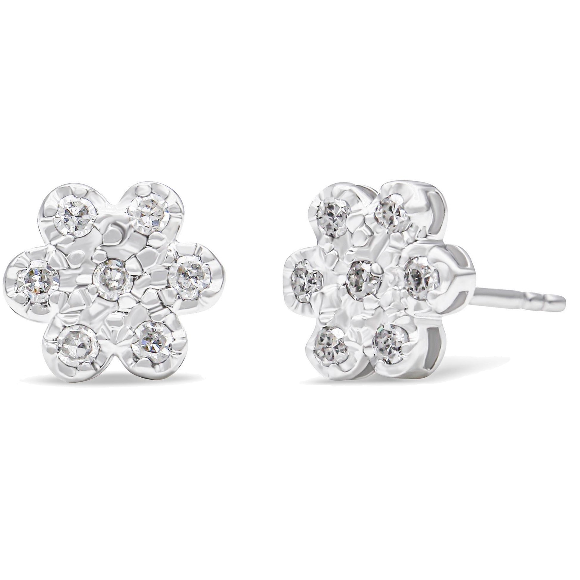 Front and side angled view of white metal flower-shaped stud earrings with round white gemstones in prong settings.