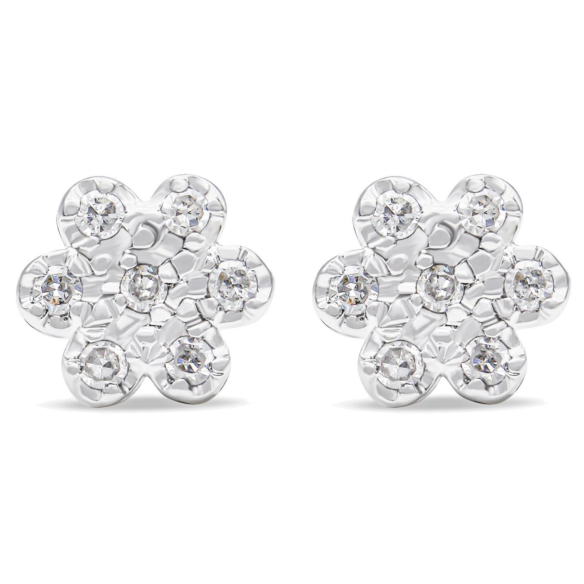 Front view of a pair of white metal flower-shaped earrings with round white gemstones in prong settings.