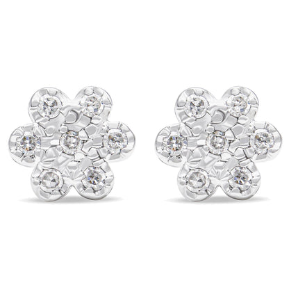 Front view of a pair of white metal flower-shaped earrings with round white gemstones in prong settings.