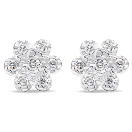 Front view of a pair of white metal flower-shaped earrings with round white gemstones in prong settings.