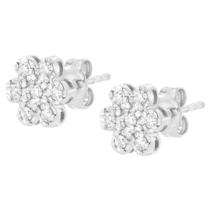 Pair of white metal stud earrings with round white gemstones in a flower shape, shown from a slight side angle.