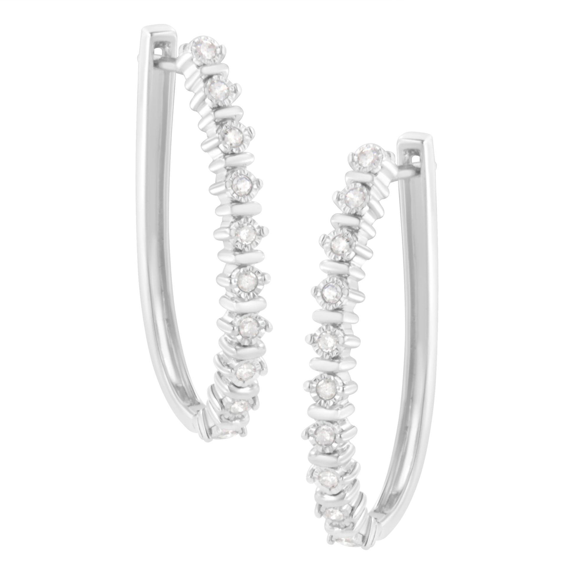 Close-up front angle view of white metal hoop earrings with round white gemstones in a miracle setting.