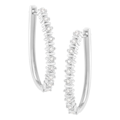 Close-up front angle view of white metal hoop earrings with round white gemstones in a miracle setting.