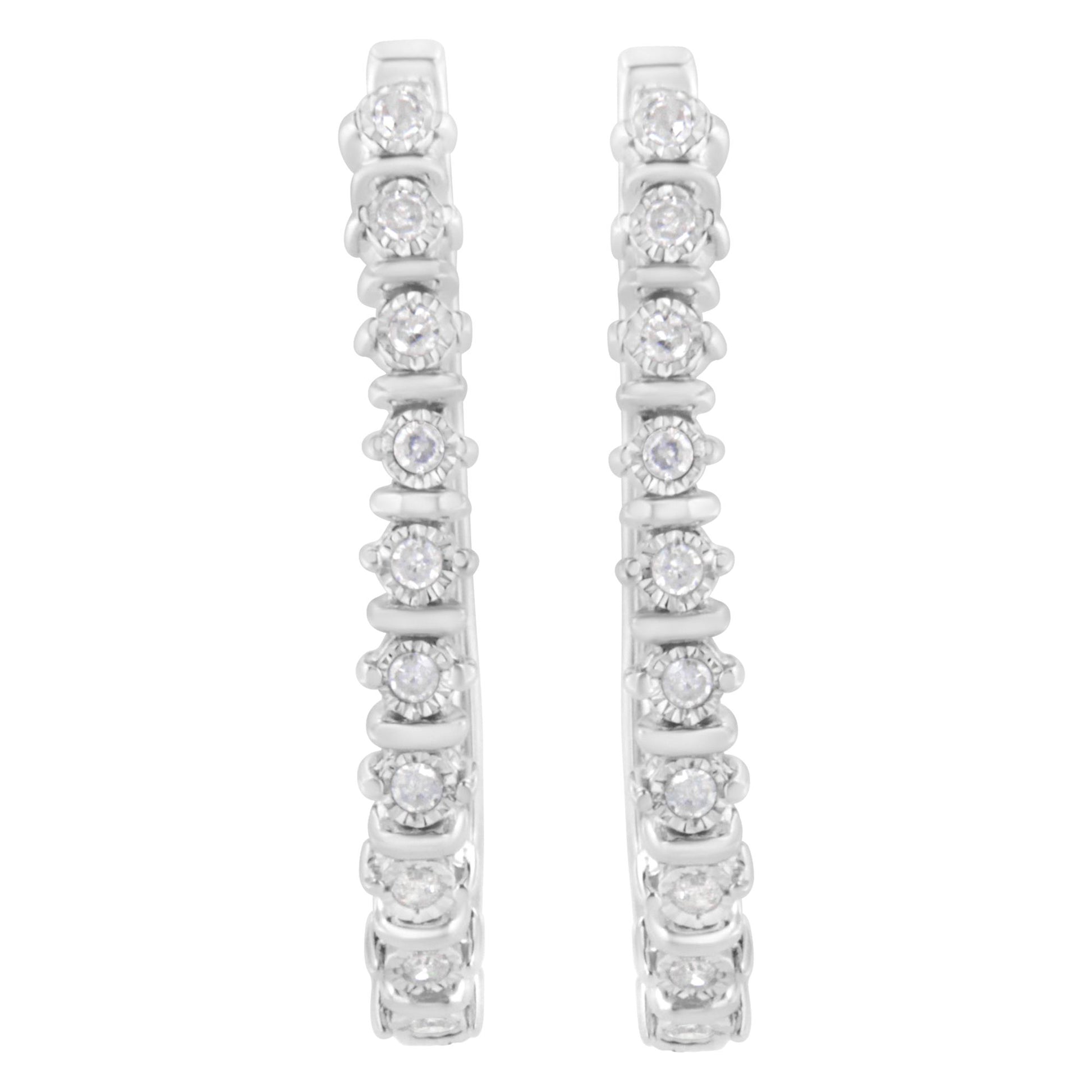 Front view of white metal hoop earrings set with round white gemstones in a miracle setting.
