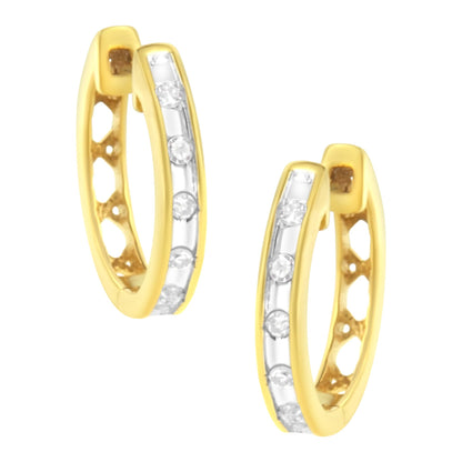 Pair of yellow metal hoop earrings with channel-set round white gemstones, shown from a front angled view.