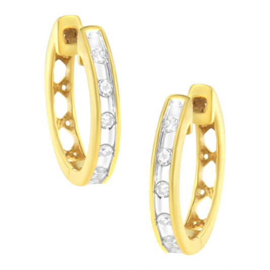Pair of yellow metal hoop earrings with channel-set round white gemstones, shown from a front angled view.