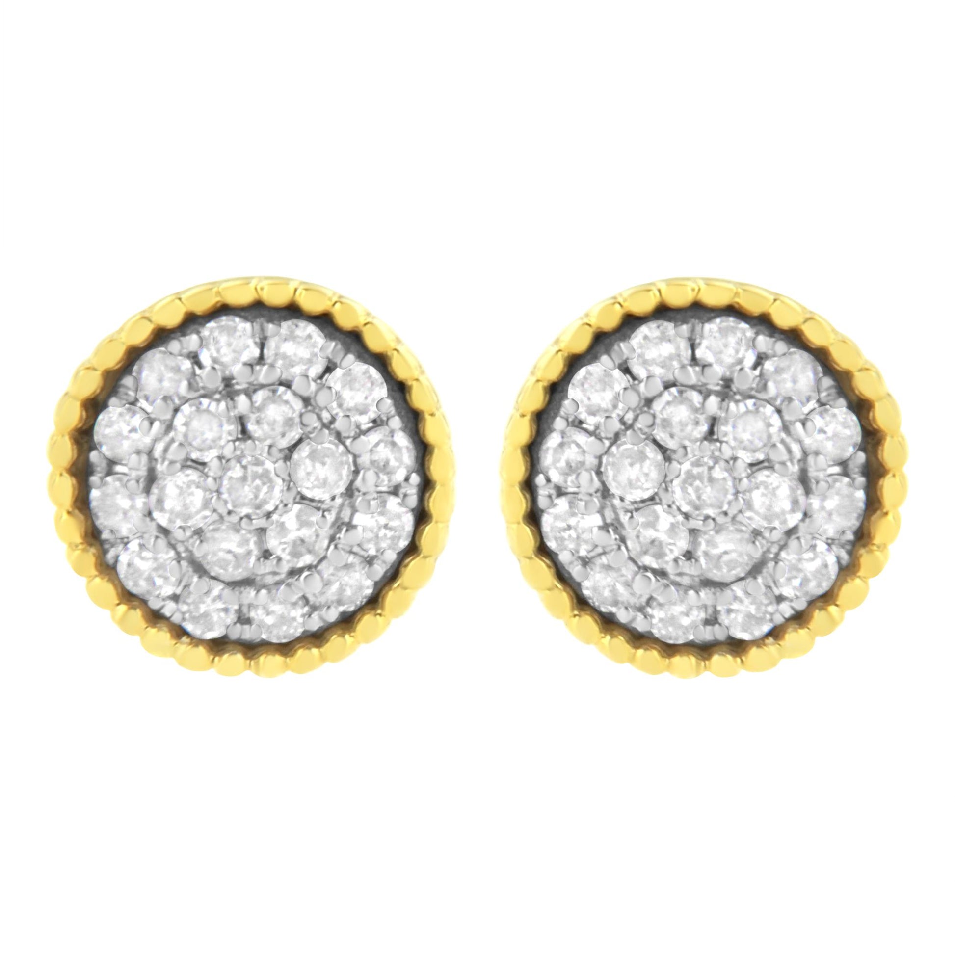 Front view of round stud earrings with white gemstones in a prong setting, surrounded by yellow metal scalloped edges.