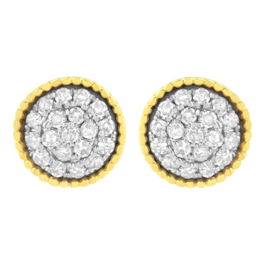 Front view of round stud earrings with white gemstones in a prong setting, surrounded by yellow metal scalloped edges.