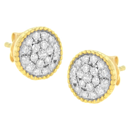 Close-up front angle of a pair of round earrings with white gemstones in prong settings, surrounded by yellow metal edges.