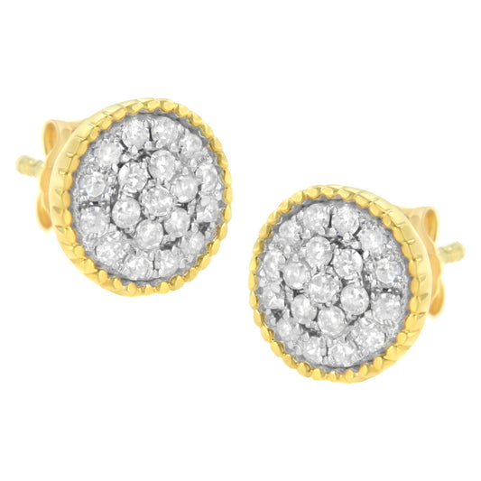 Close-up front angle of a pair of round earrings with white gemstones in prong settings, surrounded by yellow metal edges.