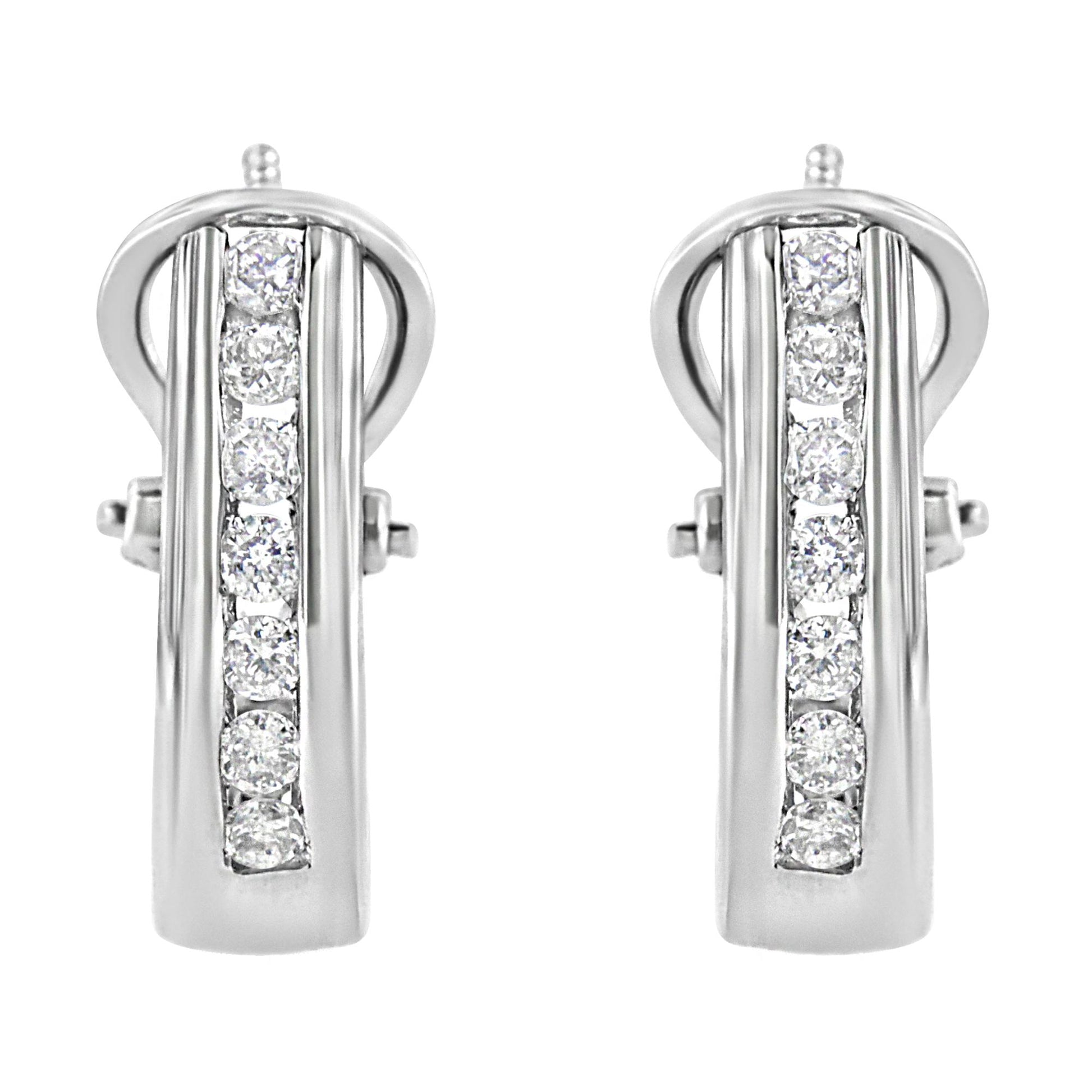 Front-facing view of white metal earrings with a vertical row of round white gemstones in channel setting.
