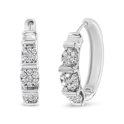 Pair of white metal hoop earrings with clusters of round white gemstones in prong settings, shown from front and angled side views.