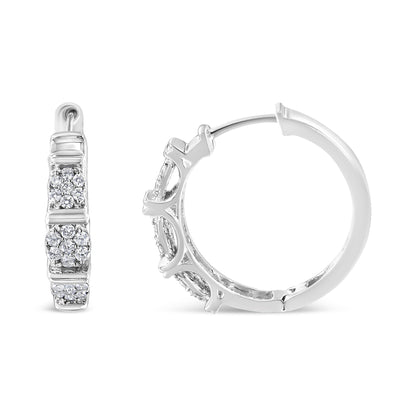 Front and side view of white metal hoop earrings featuring clusters of round white gemstones in prong settings.