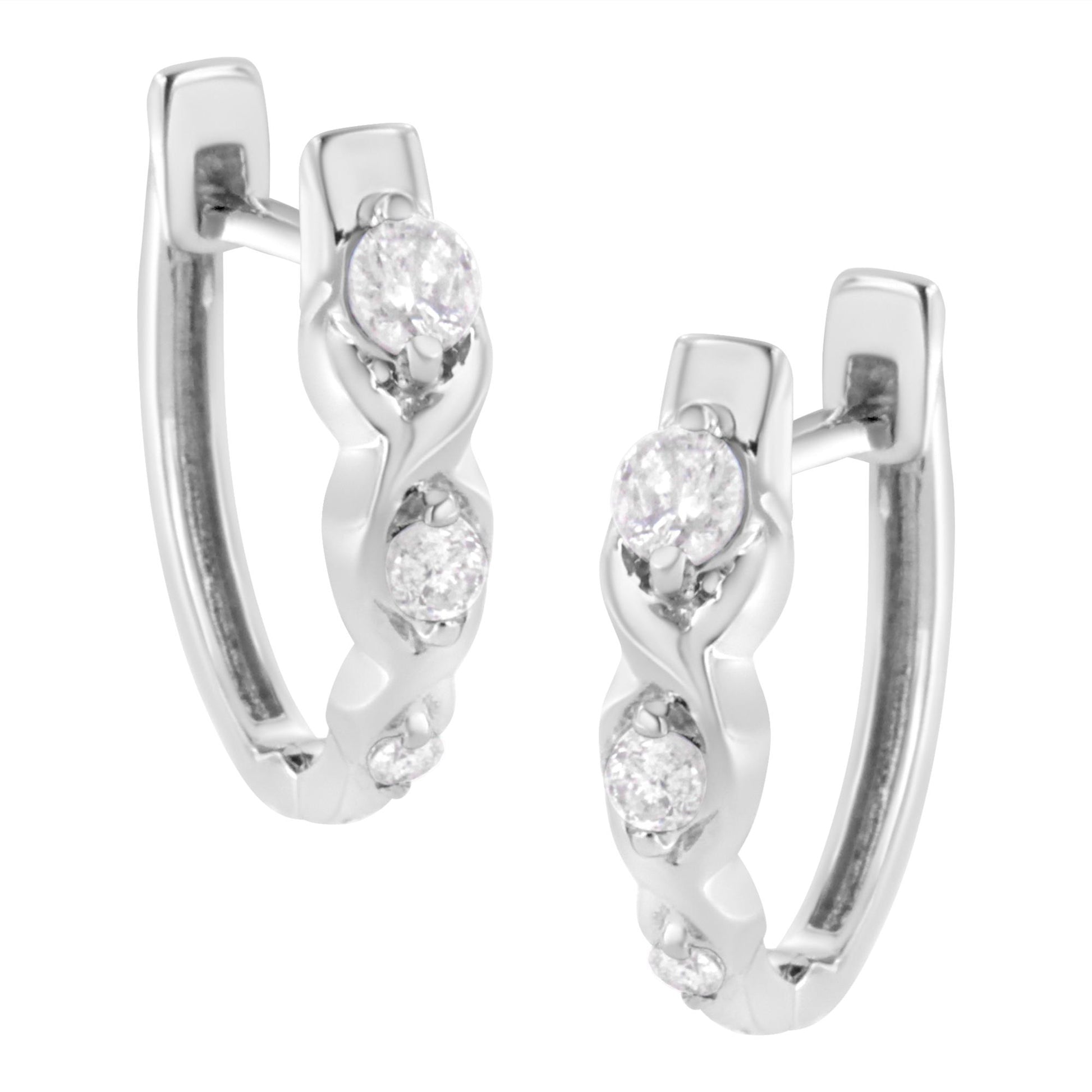 Close-up front angle of white metal hoop earrings featuring multiple round white gemstones in prong settings along the front curve.