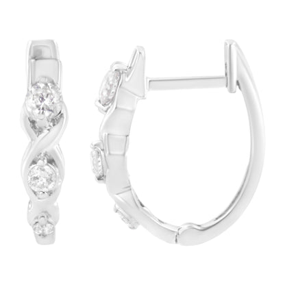 Close-up front and side views of white metal hoop earrings featuring round prong-set white gemstones in a twisted design.