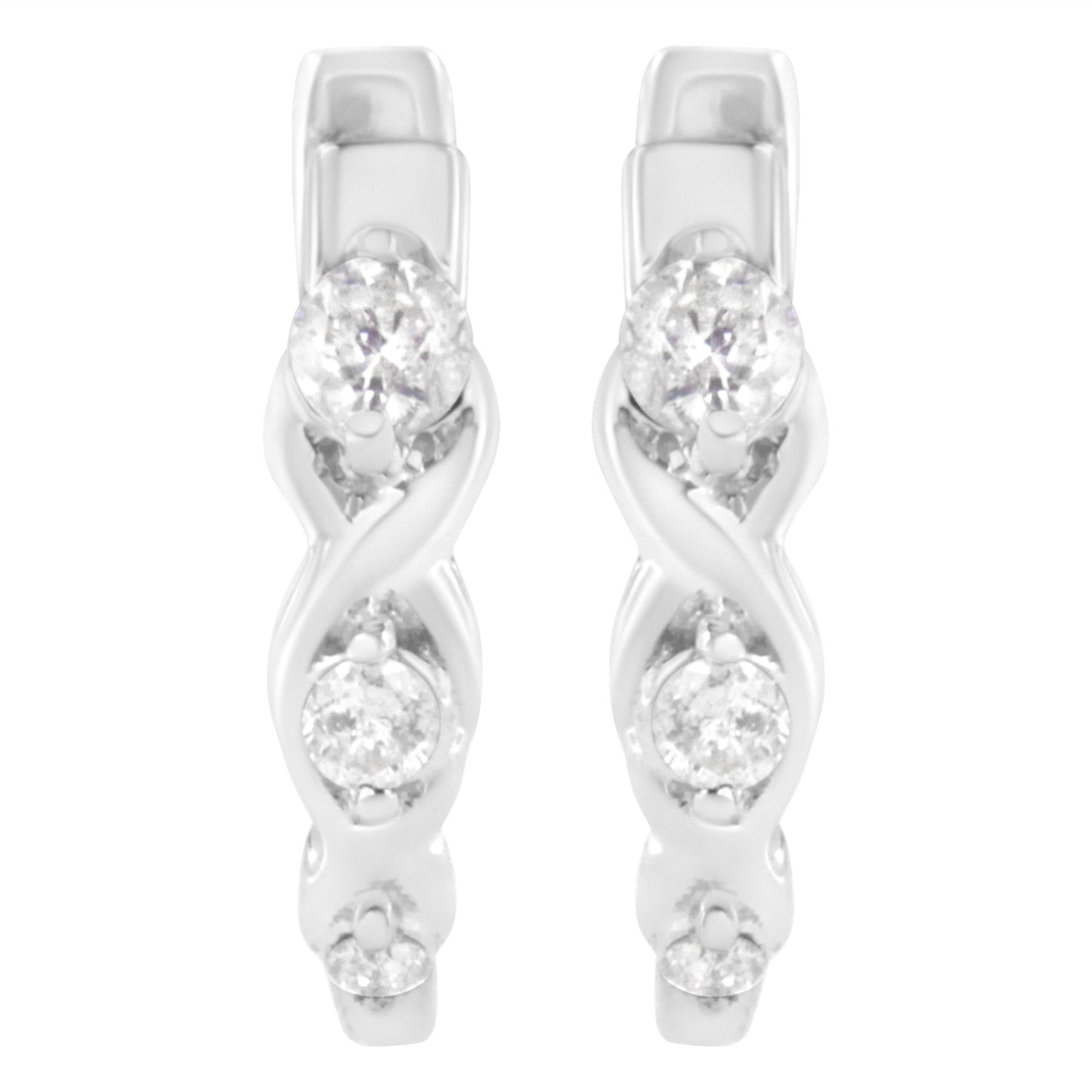 Front angle view of white metal earrings with an intertwined design and three round white gemstones in prong settings on each earring.