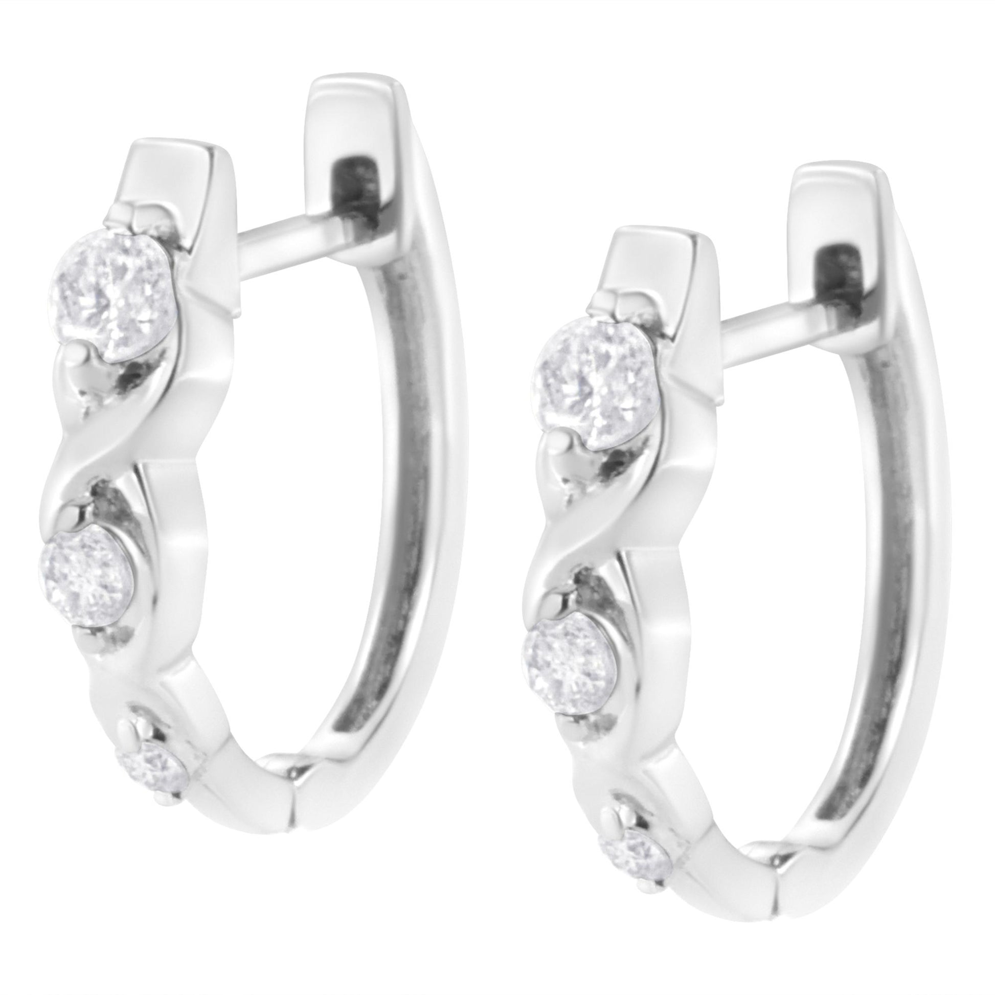 Pair of white metal hoop earrings set with multiple round white gemstones, shown in a front angled close-up view.