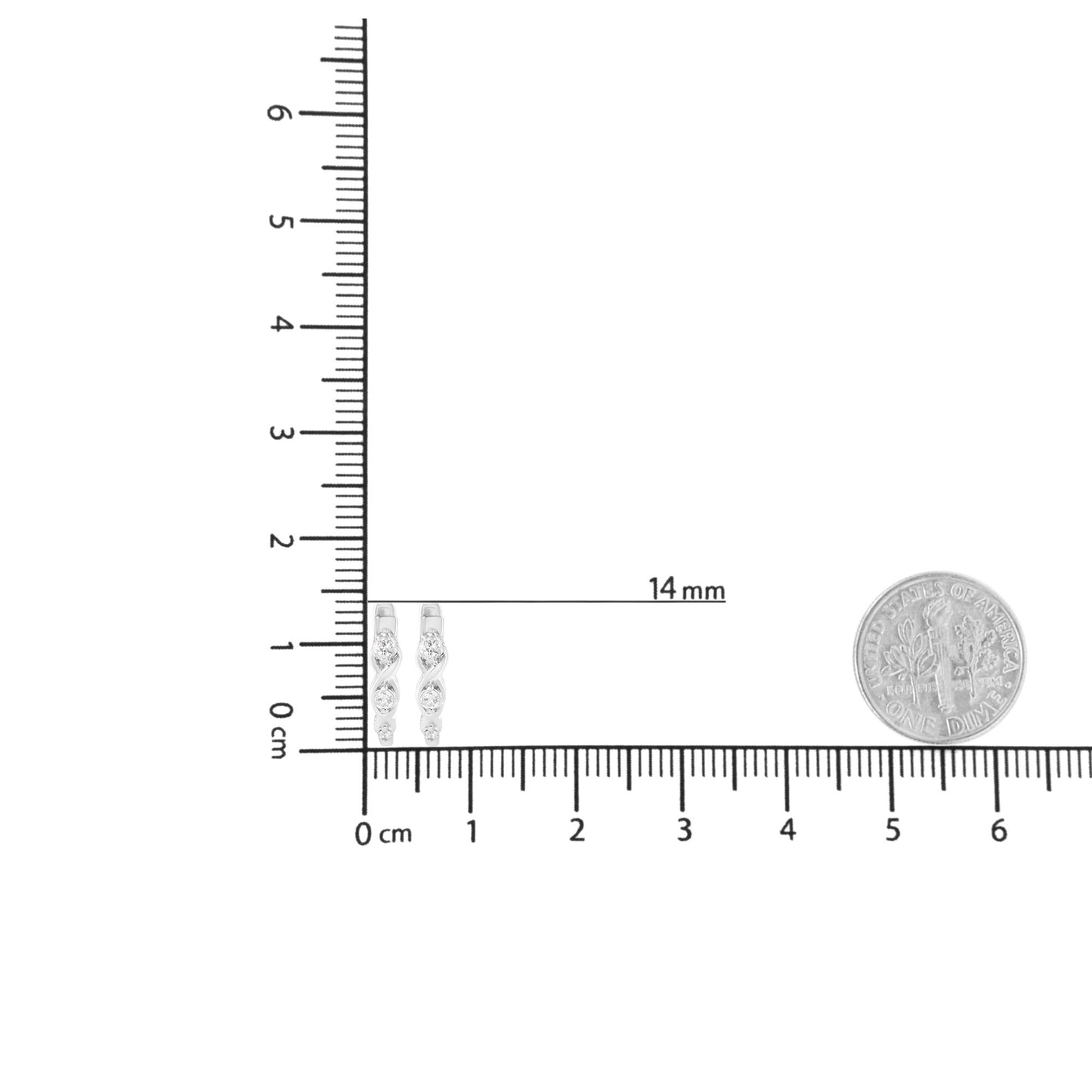 Pair of white metal earrings with three round white gemstones set in prongs, displayed on a ruler for size reference, front angle.