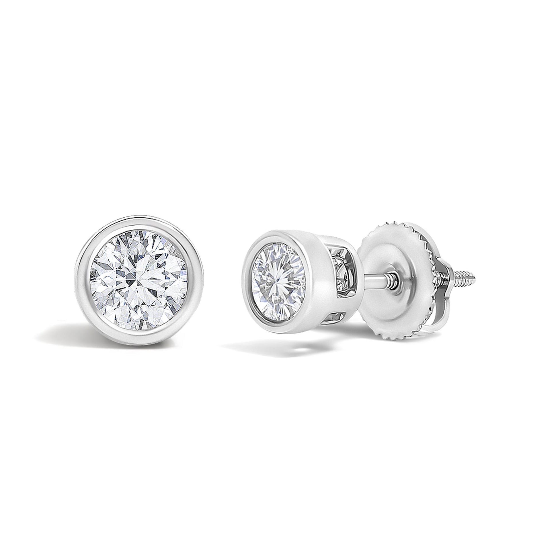 Pair of white metal stud earrings with round white gemstones in bezel settings, shown in a close-up angled view.
