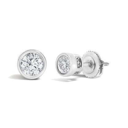 Pair of white metal stud earrings with round white gemstones in bezel settings, shown in a close-up angled view.