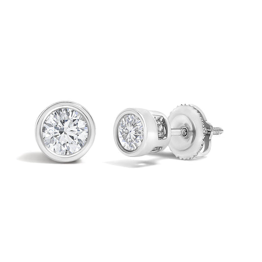 Pair of white metal stud earrings with round white gemstones in bezel settings, shown in a close-up angled view.
