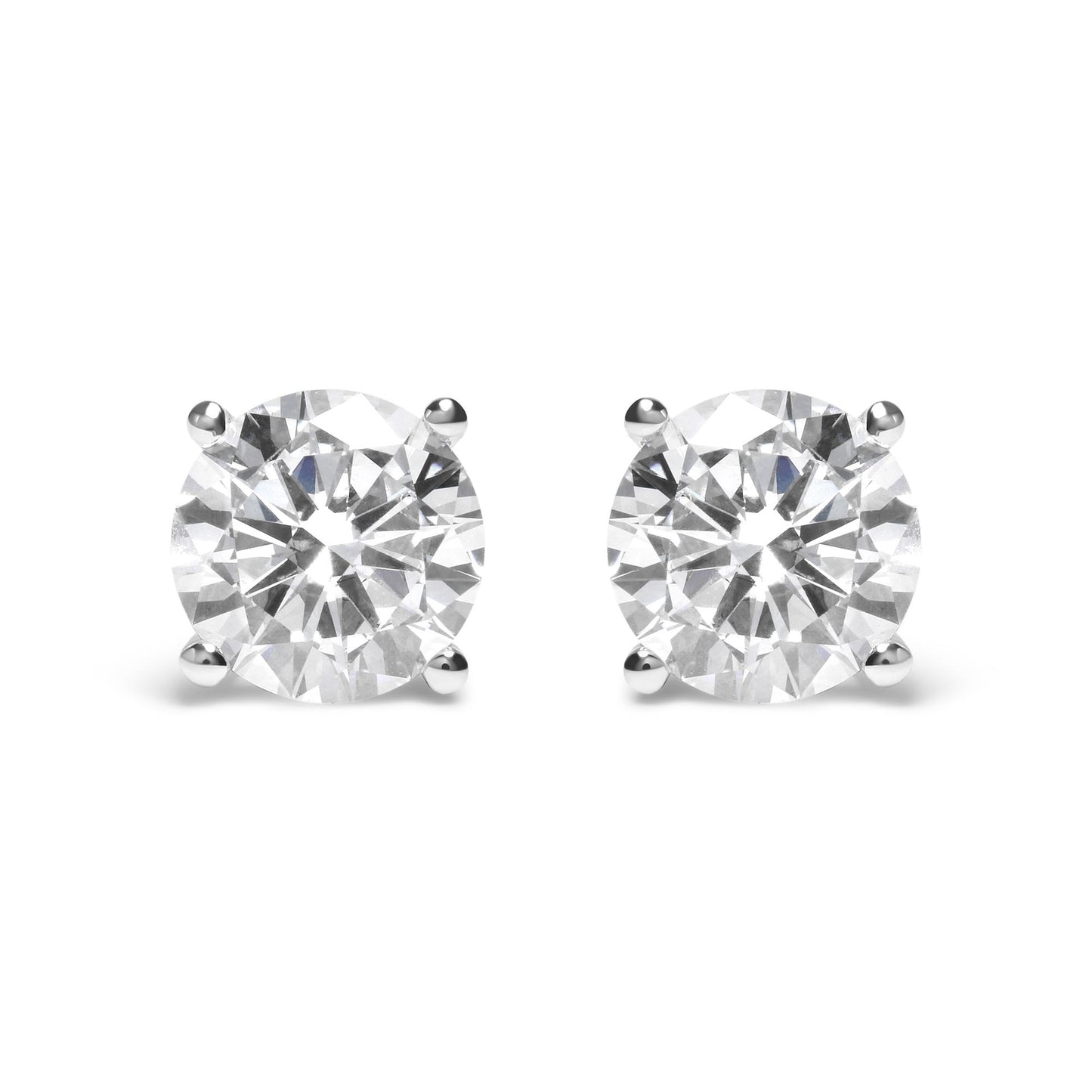 Pair of white metal stud earrings with round white gemstones in 4-prong settings, front view.