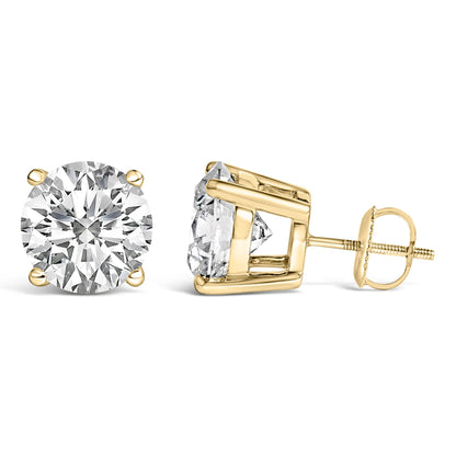 Pair of yellow metal stud earrings with round white gemstones in four-prong settings, shown from front and side angles against a white background.