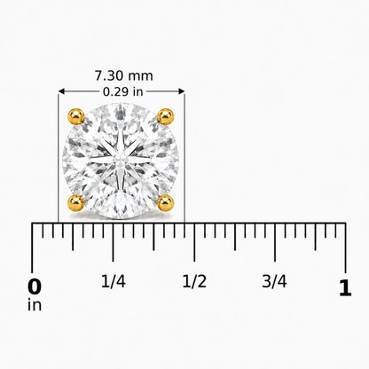 Close-up front angle of a yellow metal earring featuring a round white gemstone set in a four-prong setting, shown on a scale with measurements.