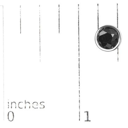 Close-up shot of a single white metal earring with a round black gemstone in a bezel setting on a ruler for size reference.