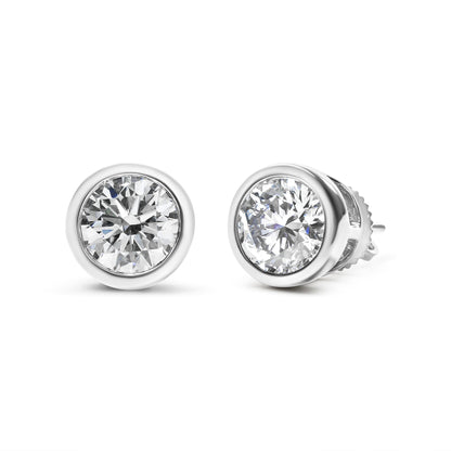 Close-up front angle of white metal round bezel-set stud earrings with white gemstones.