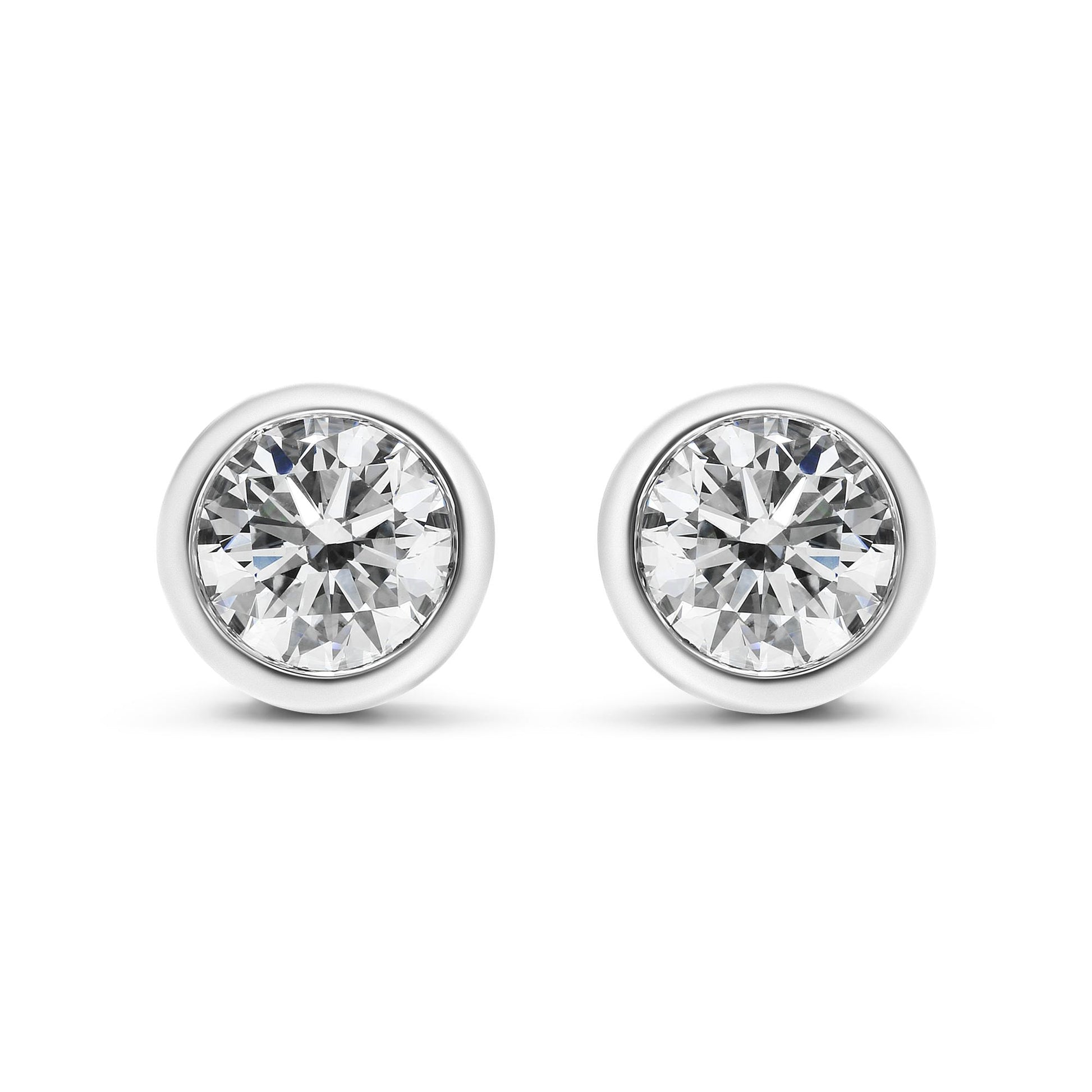 Front view of white metal round bezel-set white gemstone stud earrings.