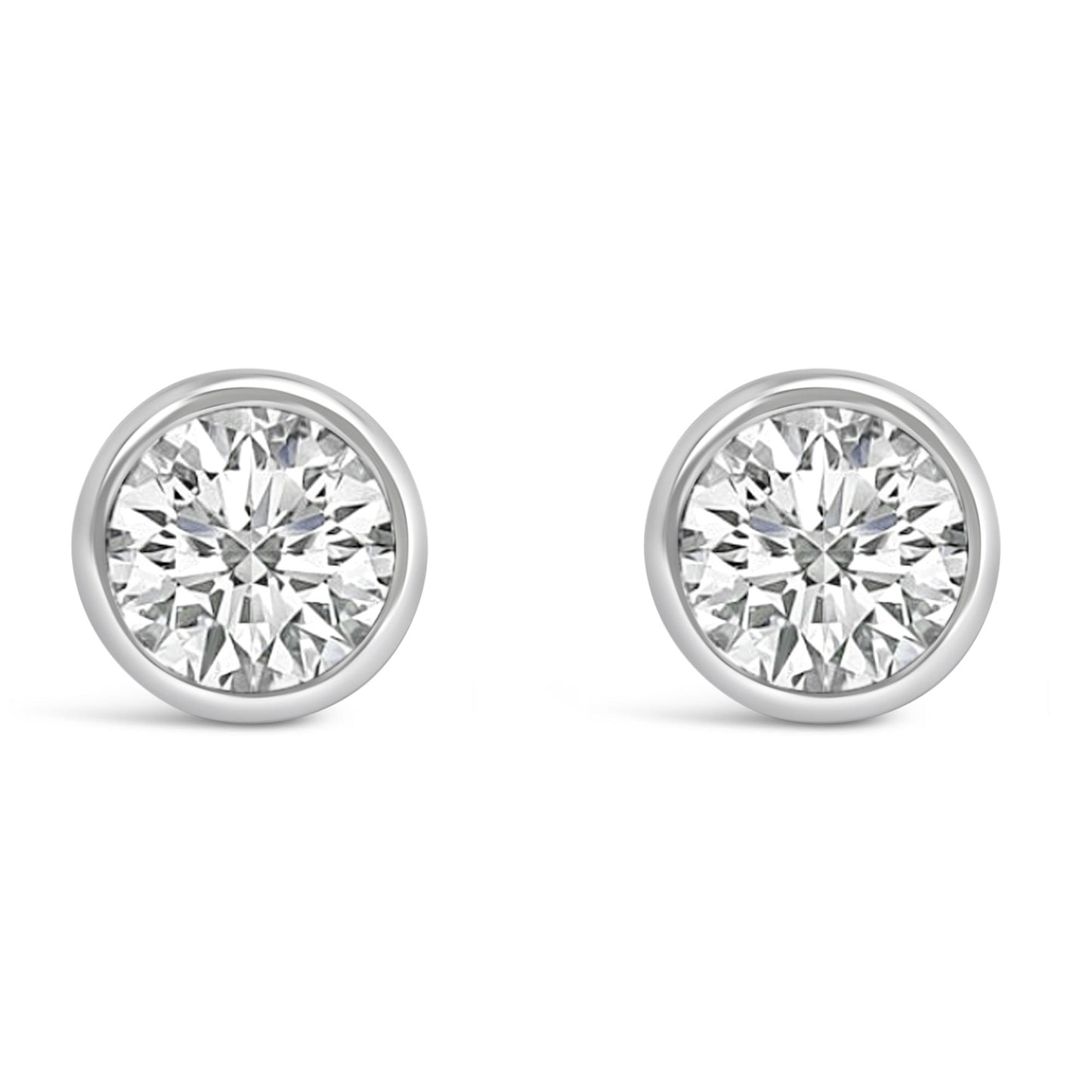 Front view of a pair of white metal bezel-set round white gemstone stud earrings.