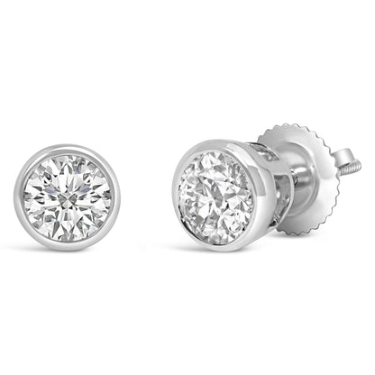 Close-up front and side view of a pair of white metal earrings with round white gemstones in bezel settings.