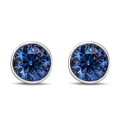 Front view of white metal stud earrings with round blue gemstones in bezel settings.