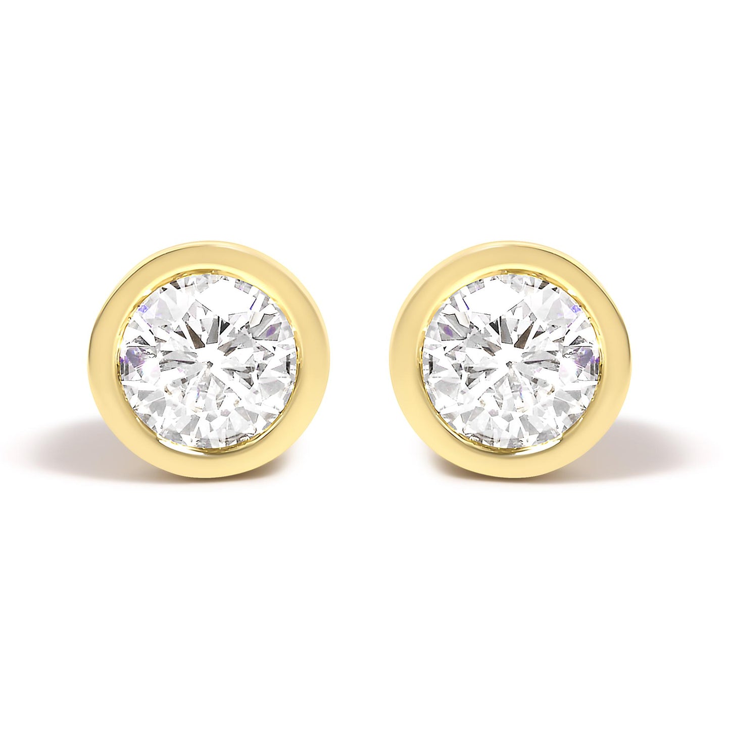 Front view of a pair of yellow metal stud earrings each featuring a round white gemstone in a bezel setting.