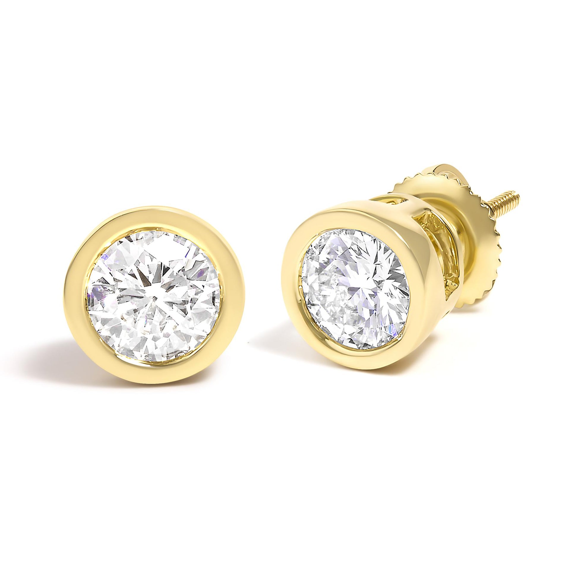 Close-up front and angled view of yellow metal stud earrings with round white gemstones in bezel setting.