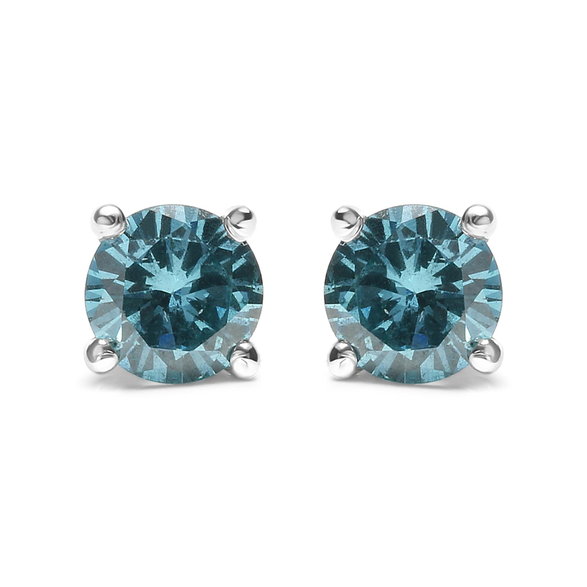 Front view of white metal stud earrings featuring round aqua blue gemstones in prong settings.