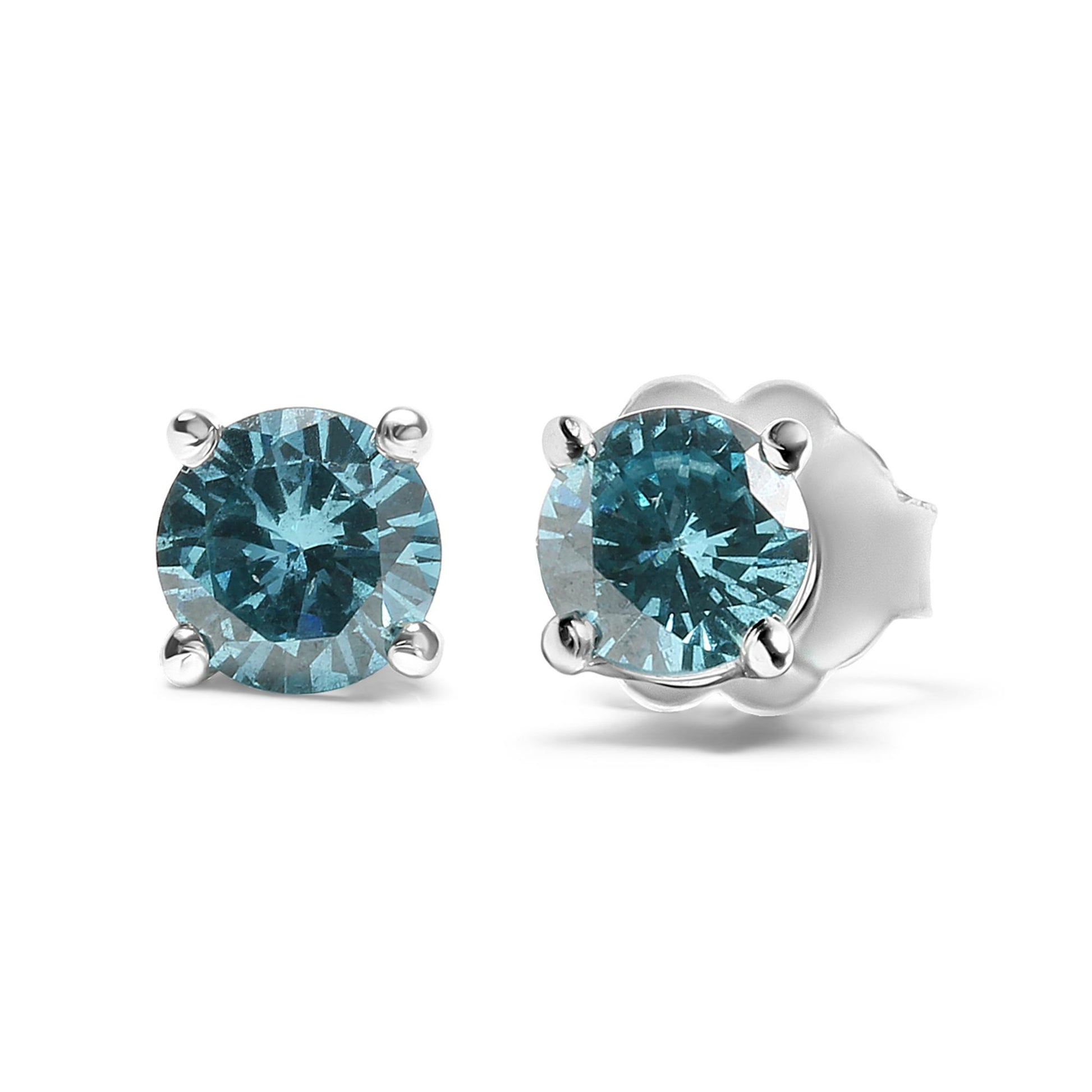 Pair of white metal stud earrings with round aqua blue gemstones in prong settings, shown from a slightly angled front view.