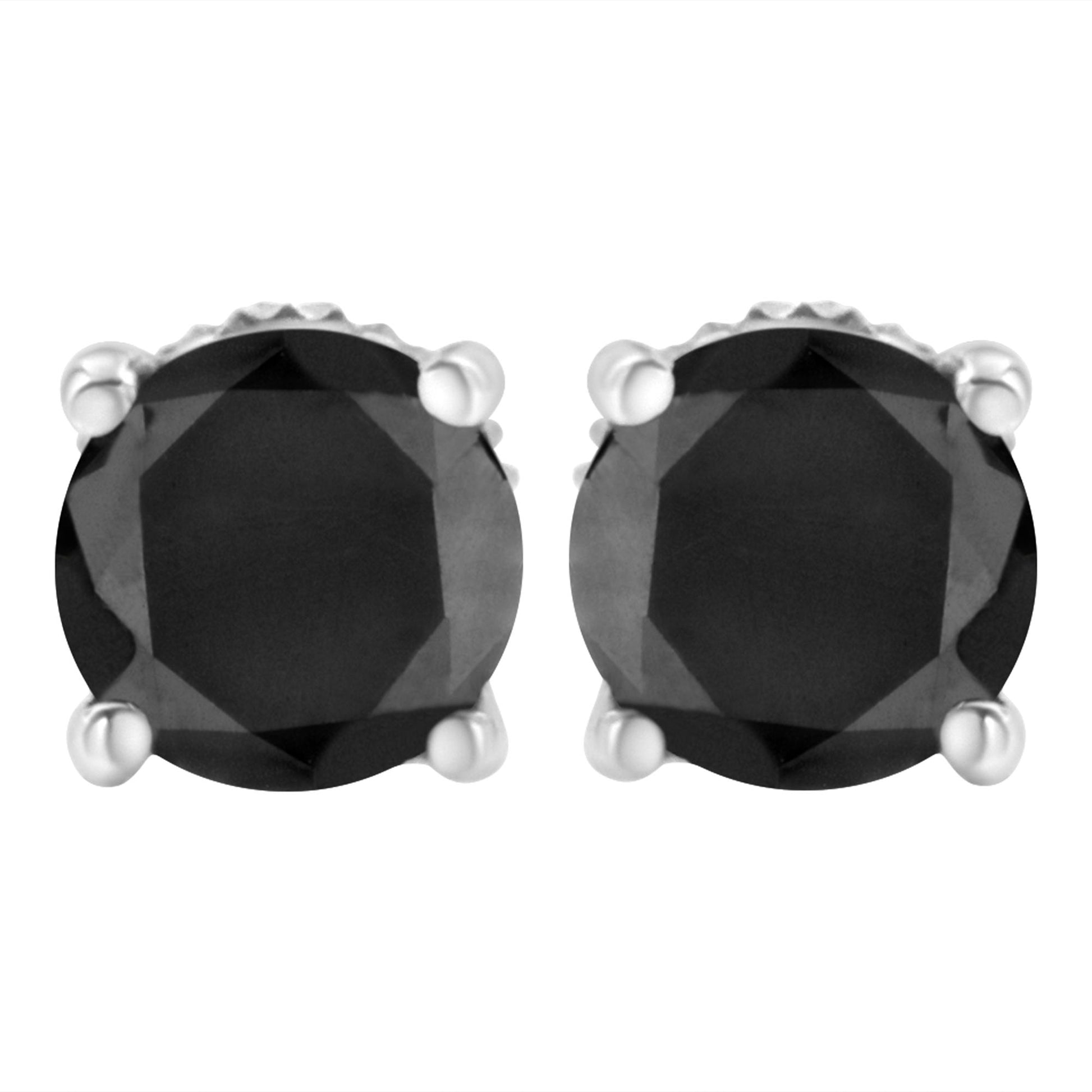 Front view of a pair of white metal stud earrings with round black gemstones in prong settings.