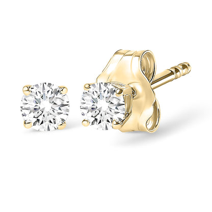 Close-up front and side view of yellow metal stud earrings with round white gemstones in four-prong settings.