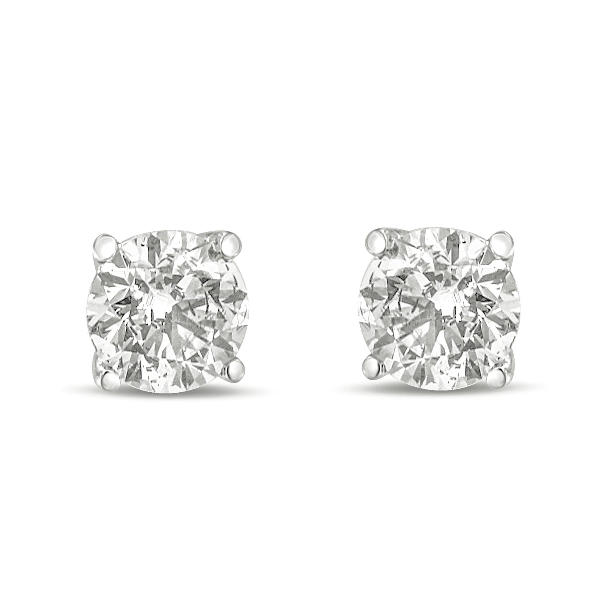 Front view of white metal round gemstone stud earrings with four-prong settings.