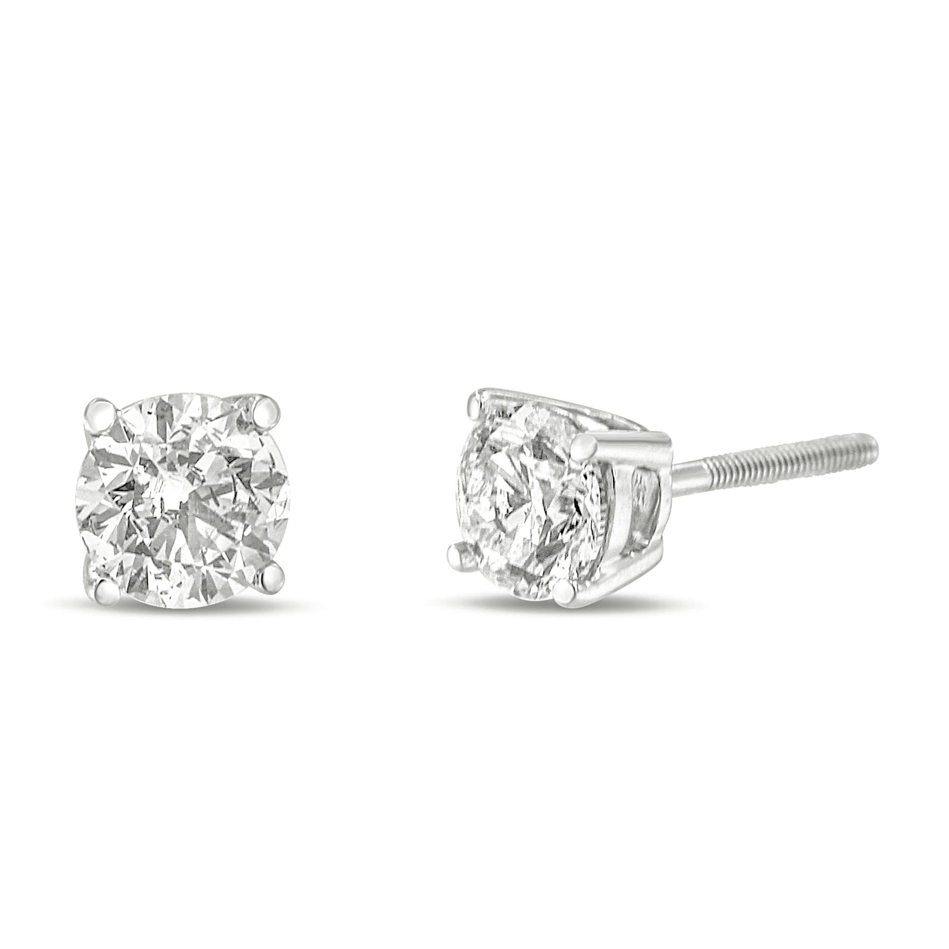 Front and side angle view of white metal stud earrings with round white gemstones in 4-prong settings.