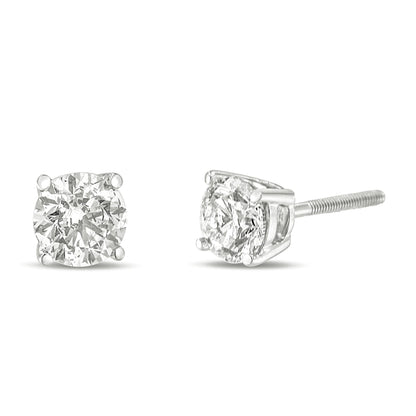 Front and side angle view of white metal stud earrings with round white gemstones in 4-prong settings.