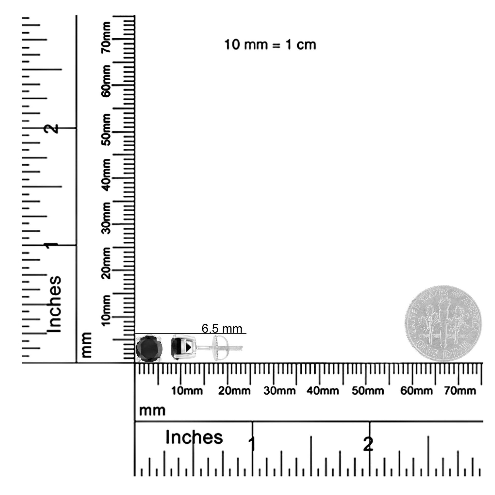 Top-down view of white metal stud earrings with round black gemstones in prong settings, displayed on ruler and scale for size reference.