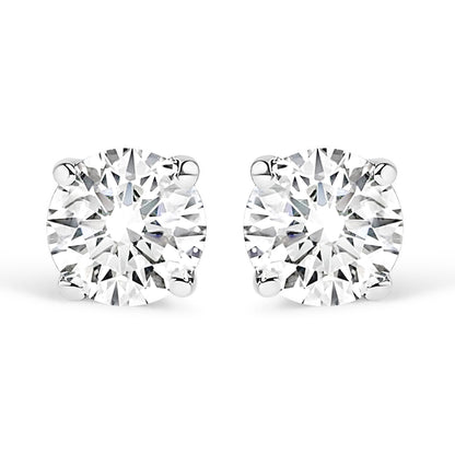 Close-up front view of a pair of white metal stud earrings, each featuring a round white gemstone in a four-prong setting, shown against a white background.
