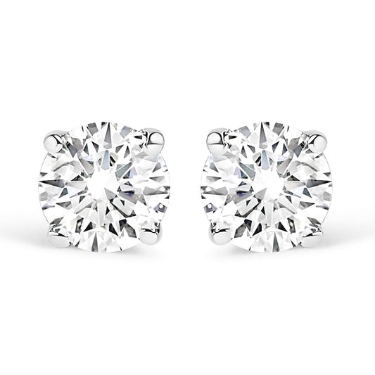 Close-up front view of a pair of white metal stud earrings, each featuring a round white gemstone in a four-prong setting, shown against a white background.