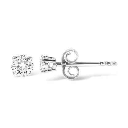 White metal stud earrings with round white gemstones in four-prong settings, shown from the side on a white background.
